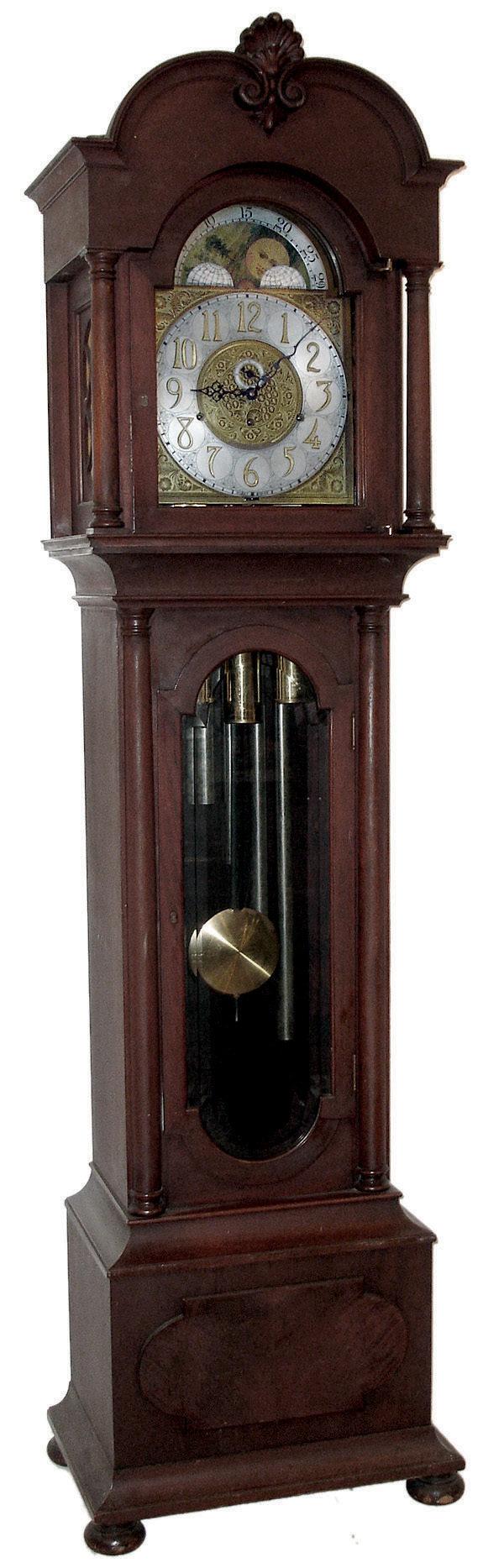 Herschede Clock Co., Cincinnati, Ohio, 8 days, time, strike and triple brass, weight driven, German movement with Westminster chimes on six tubes. Mahogany case with beveled trunk glass, carved top and bun feet. Brass dial with silvered chapter ring and moon phases, c1910 — Antique Clocks Price Guide