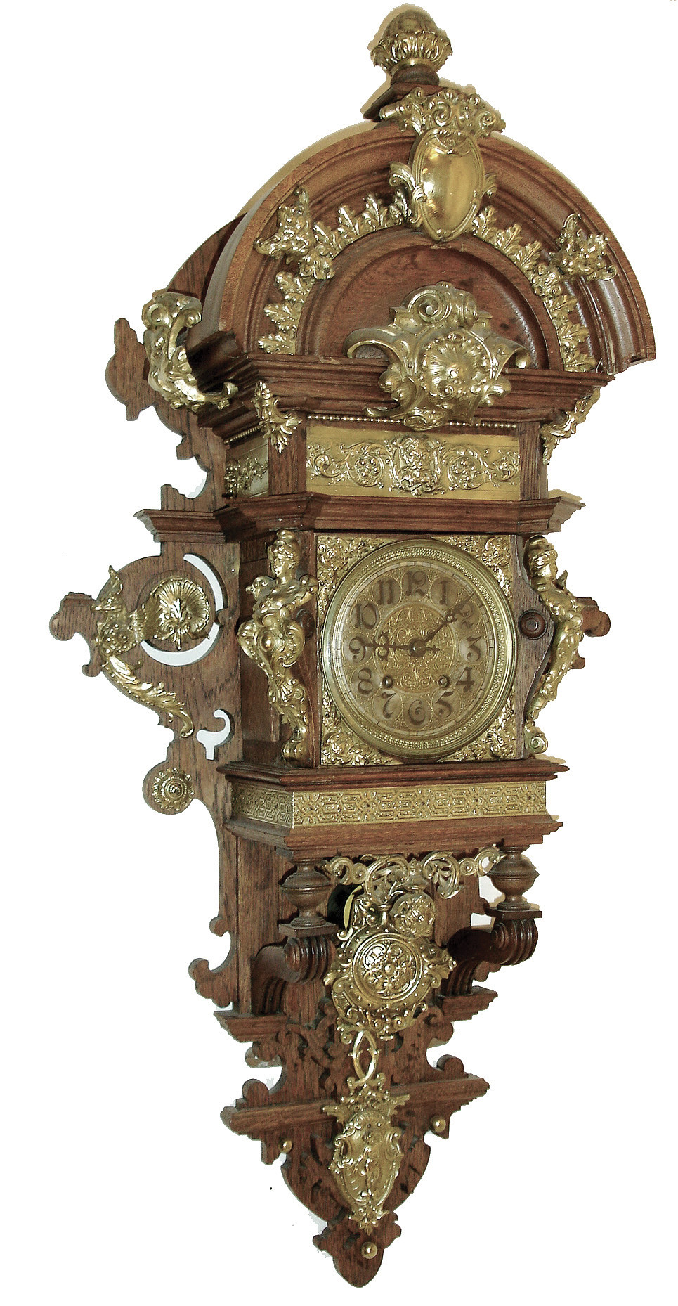 Lenzkirch, Germany, walnut open well or ÓFreischwingerÒ, with built-in top and with approximately 24 pieces of brass decoration and the fancy cast pendulum bob. The well made movement is series number 26 bearing the Lenzkirch logo and serial number 527880, fancy engraved brass dial with gilt highlights, c1873 includes a brass presentation plaque written in old German — Antique Clocks Price Guide