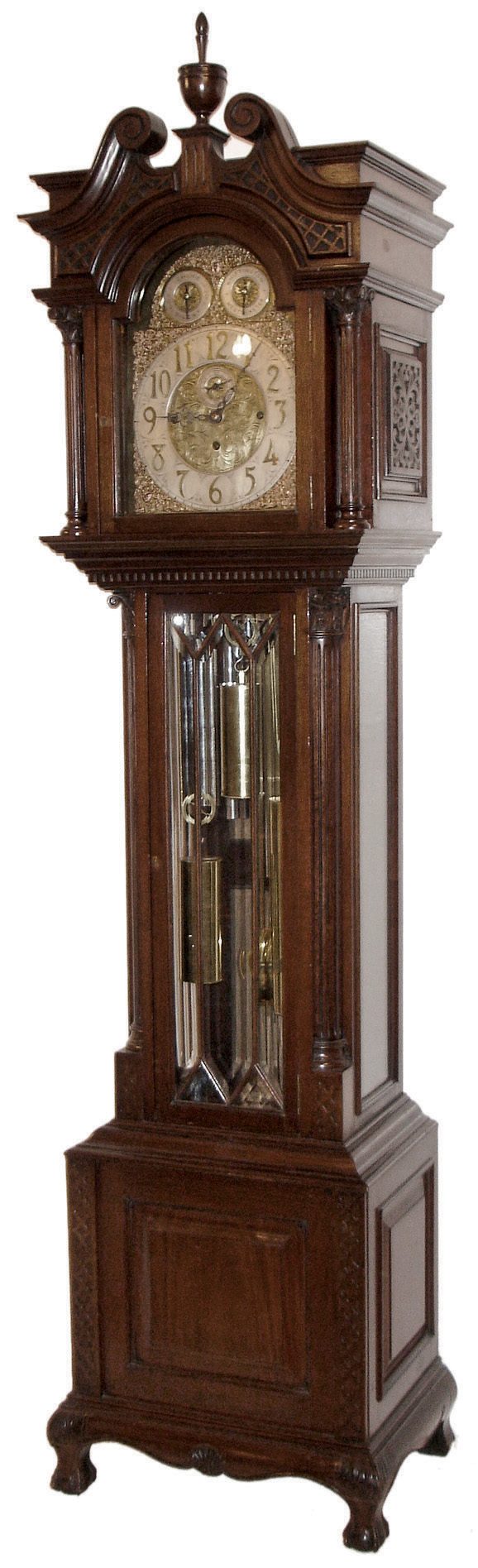 J.J. Elliott, London, England tall case clock, 8 days, time, strike and Westminster &amp; Whittington chime on nine tubes, Triple brass, weight driven movement in a mahogany case with full round fluted Corinthian columns flanking hood, fluted Corinthian corner columns flanking trunk door, pierced carved side frets, dental molding below hood, seven pane beveled glass trunk door and sides on a base with flat carved side columns flanking a raised center panel and hairy ball and claw feet. The brass dial has raised silver chapter ring and two subsidiary dials for Strike / Silent and tune selection, all surrounded by ornately cast brass trim and spandrels with nicely engraved dial center, c1910 — Antique Clocks Price Guide