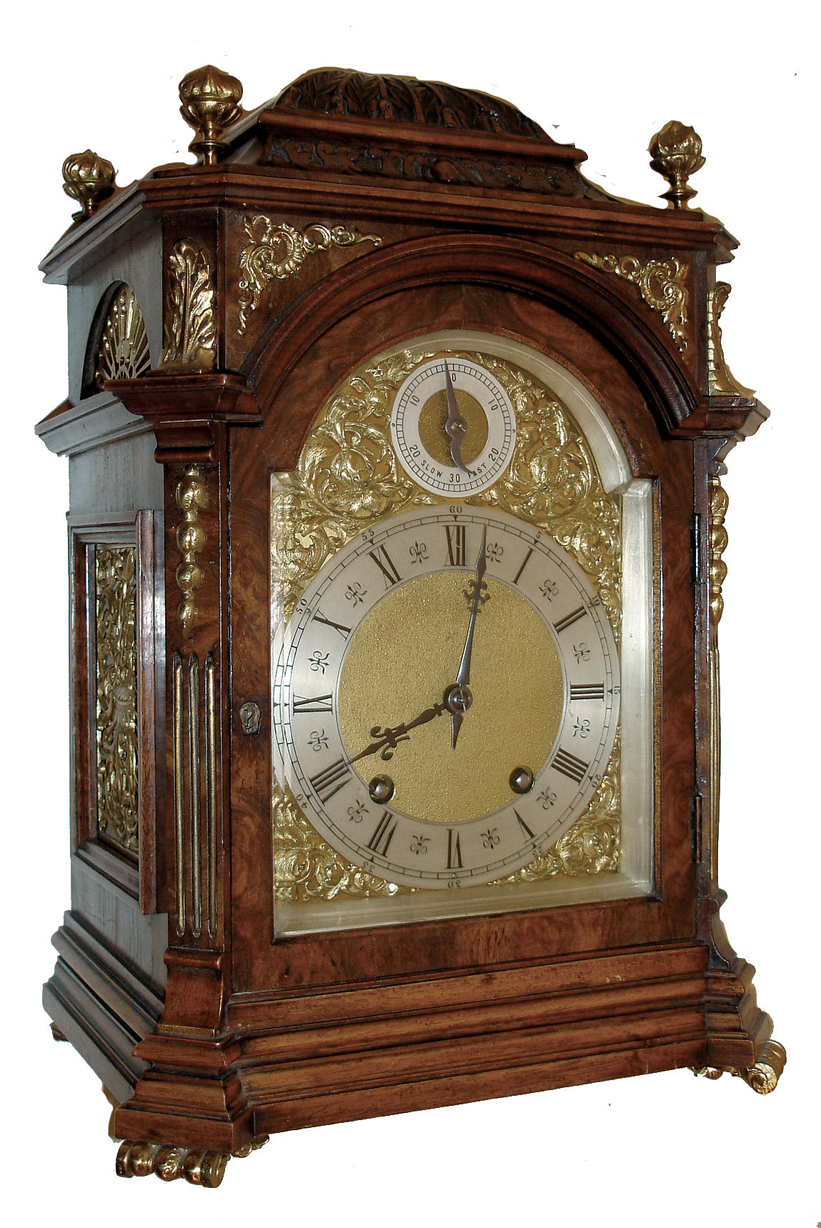 Lenzkirch, Germany, shelf or mantel clock of typical bracket clock form, walnut and burl walnut veneers and with classically inspired moldings, top with foliate carving, gilt scroll feet, gilt flame finials, and with gilt frets and spandrels showing strong Jugendstil influence, composite dial with Roman numeral silvered chapter ring and with regulating hand and scale in the arch, blued steel hands, 8 days, time and strike, movement with ting tang striking, serial No. 1,188,953, c1900 — Antique Clocks Price Guide