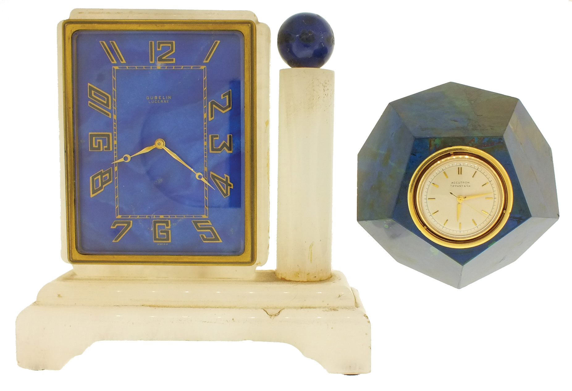 Clocks- 2 (Two): An Art Deco style desk clock with alabaster case and lapis lazuli dial marked ÓGubelin LucerneÒ, and a trapezohedronal confusionite (possibly also lapis), paperweight clock mounted with an 18 karat yellow gold Accutron calibre 214 timepiece, the dial and case signed Tiffany &amp; Co. — Antique Clocks Price Guide