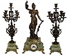 Clocks- 2 (Two): (1) France, large and impressive 3 piece figural mantel garniture, the clock case of green onyx on gilt leaf and scroll ornamented paw feet, gilt dial surround in the rococo style, surmounted by a patinated spelter female figure representing Abundance, the front of the sculpture with applied plaque reading ÓAbondance par GuilleminÒ, the sculpture also signed ÓL. GuilleminÒ, gilt bezel with beveled glass, Arabic numeral white enamel dial with illegible signature, blued steel hands, 8 days, time and strike, pendule a Paris movement marked Vincenti, the companion candelabras with patinated surfaces and racially ornament, resting on green onyx bases and also with gilt paw feet, c1890; (2) Painted metal figural Ansonia rear-wind, 30 hours, clock, c1885 with later adaption to an electric lamp with 1920Õs style shade.