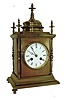 France, a polished brass desk clock of architectural form, with 4 free standing columns at the corners, a temple top and 5 finials, and an 8 days, bell strike movement, c1890