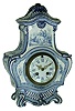 Clocks- 2 (Two) European: (1) French Delft-style porcelain clock, Japy Freres Medaille DÕHonneur, 8 days, time and strike, movement, c1890; (2) English, F. W. Elliott, Croydon, Westminster chime bracket clock in a solid panel rabbeted case, and with composite brass dial, with tune selections of Whittington or Westminster. 8 days movement with platform lever at top of movement. This is all English manufacture, not a Continental movement, c1960