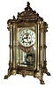 Ansonia Clock Co., New York, EXCELSIOR, crystal regulator, with cast female bust pendulum, and with multi color, creamy porcelain dial with red decorations between the Arabic numerals, and with open escapement on the dial, c1904