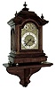 Germany, bracket clock with shelf, walnut and walnut veneer case with heavily molded top and base, composite dial with gilt spandrels, and Roman numeral silvered chapter ring, fancy blued steel hands, sides with cast frets with rococo style ornament, 8 days, three train movement sounding Westminster chimes on gongs, and counting the hours on a large gong, c1900