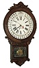 William L. Gilbert Clock Co., Winsted, Conn., ÓOffice Drop CalendarÒ model GilbertÕs revision of the Maranville-style calendar having movable discs for month and days of week. Handsome case with applied carvings and fancy burled walnut veneer. 8 days, time and strike, movement, c1881
