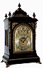 English, triple fusee, quarter chiming bracket clock, in a classic Georgian style large ebonized case with brass caryatids, side frets and pineapple finials, the whole resting on cast ÒtoedÓ feet, chiming your choice of Whittington on 8 bells or Westminster on 4 large flat wire gongs, and then sounding the hours on a still larger steel flat wire gong, the clock retailed by O. A. Strapp, Cambridge, and with an engraved cartouche below 12 bearing that information, and the arched dial with small subsidiary dials labeled Chime /Silent, F/S, and Chime on 8 Bells or Westminster, c1875