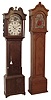 English tall case clocks- 2 (Two): (1) Wilkinson, Leicester, England 8 days, time, strike and calendar, weight driven movement in a dark oak case with false moon phase dial, c1820; (2) Unsigned, 30 hours, time and strike, endless chain movement in a hard pine case with red painted dial, silvered chapter ring and applied pewter spandrels and boss c1790