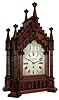Barraud & Lunds, 41 Cornhill, London, large bracket clock in the Gothic style, carved oak case with buttress corners supporting clustered columns, the door also with clustered column style ornament and topped with foliate carving, gables with carved, stepped ornament, case top surmounted by 6 octagonal pinnacles with crockets, case sides with ornately pierced wooden frets, Roman numeral silvered dial with engraved spandrels, blued steel hands, 8 days, 3 train fusee movement, with chiming on eight bells and counting the hours on a large gong, the back plate also signed , c1845