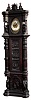English monumental tall case clock, 8 days, time, strike and chime, three brass weight driven, chain pull Elite, Germany movement in a dark oak case with highly detailed carvings including three panels on the trunk with medieval scenes flanked by carved columns above carvings of gentlemen in medieval garb in full relief and another panel with knight on bended knee. The dial is brass with a silvered chapter ring, c1900