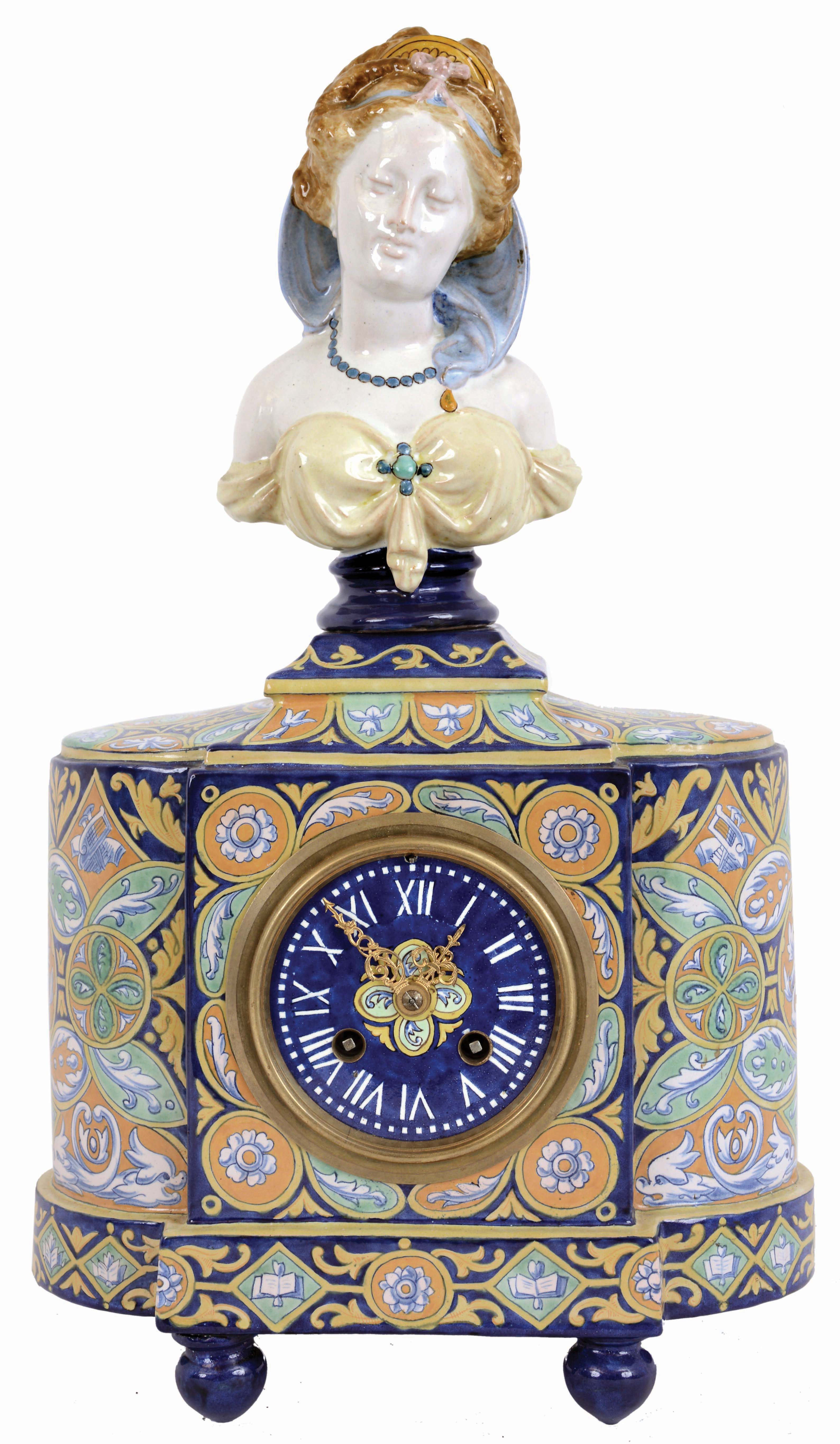 France, faience mantel clock, the earthenware case with ball feet, central square section flanked by round ends, and mounted with a female bust, all decorated in brightly colored polychrome tin glazes, and signed by the maker, Roman numeral faience dial with fancy gilt hands, 8 days, time and strike pendule a Paris movement marked Japy Freres, c1890 — Antique Clocks Price Guide