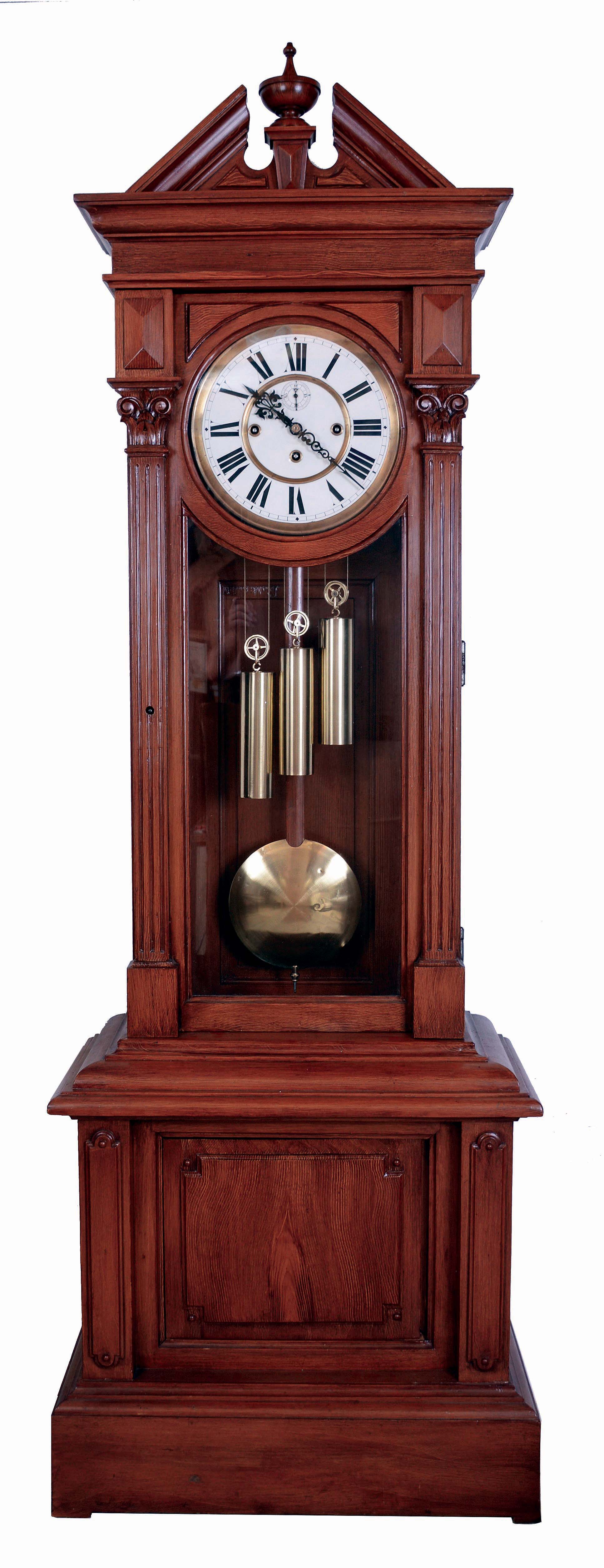 Austria, Large standing regulator tall clock, 8 days, time and grand sonnerie strike on two massive bells. Triple brass weight driven movement with dead beat escapement in a grain painted pine case with pediment top and center finial, fluted columns with Corinthian capitals flanking trunk door and two paneled glazed sides and front with a raised panel base. The white enamel dial has second's bit and fancy cut steel hands, c1890 — Antique Clocks Price Guide