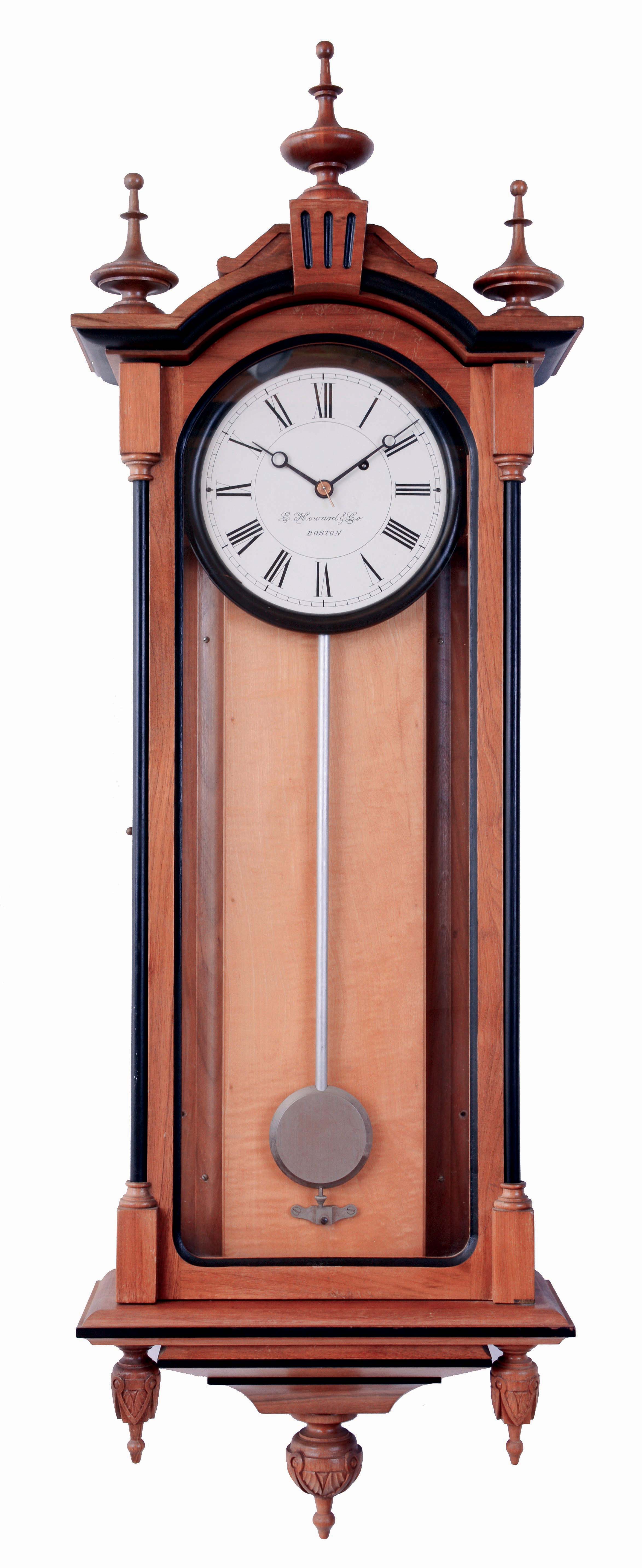 E. Howard &amp; Co., Boston, Mass., "No. 59-8 Regulator" reissue. Walnut case with ebonized moldings, turned and carved finials, maple weight baffle, ebonized wooden bezel with Roman numeral white painted dial, blued steel moon hands, nickel pendulum with silver painted wooden rod, 8 days weight driven timepiece movement, with Howard paperwork, serial #0059, August, 1976 — Antique Clocks Price Guide