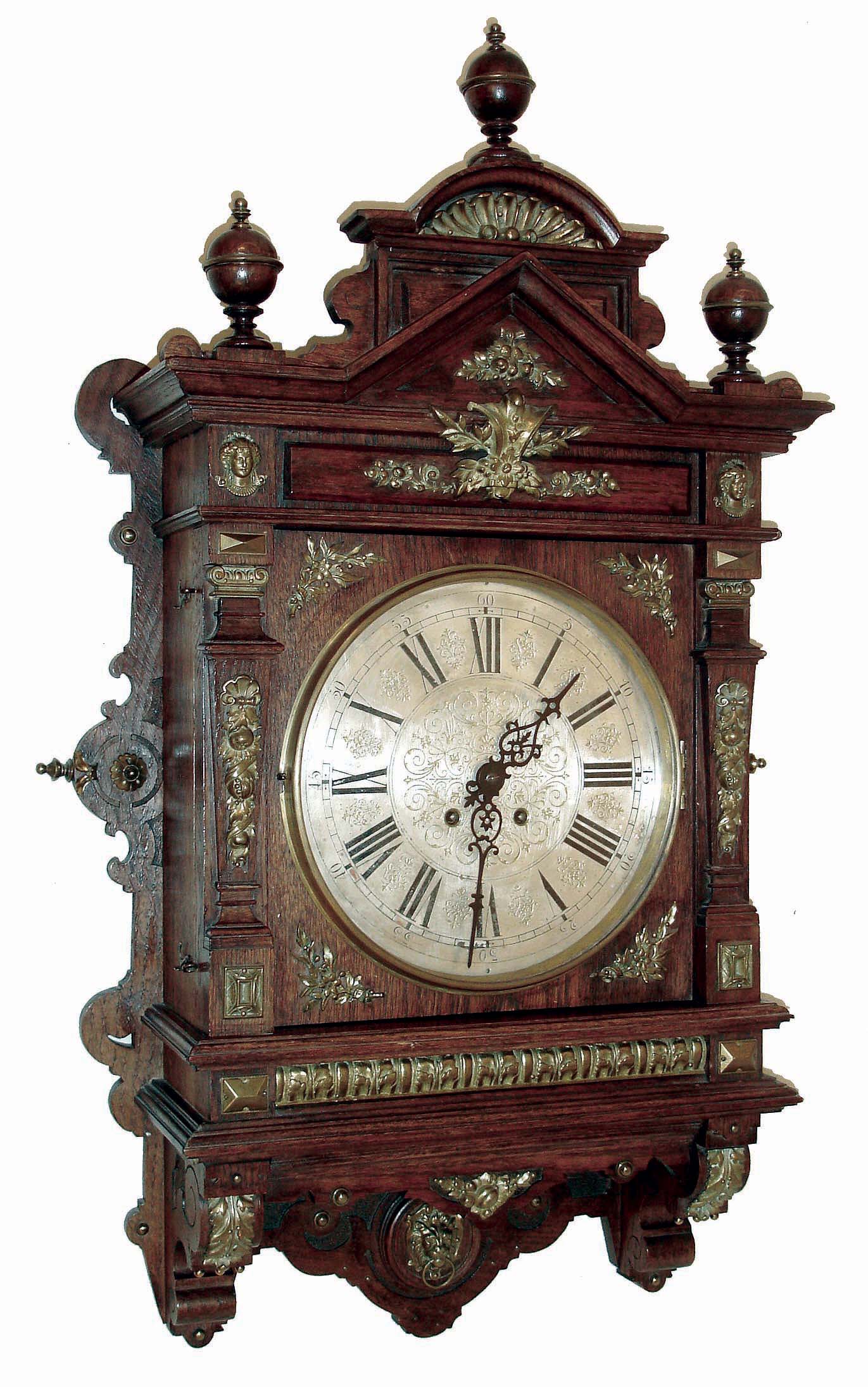 Lenzkirch, Germany, gallery clock, or Gutsherren Uhr, architectural oak case with applied cast ornaments, top with turned finials, also with applied brass decoration Roman numeral silvered dial, black painted steel hands, 8 days, time and strike movement, serial #871393, c1890 — Antique Clocks Price Guide