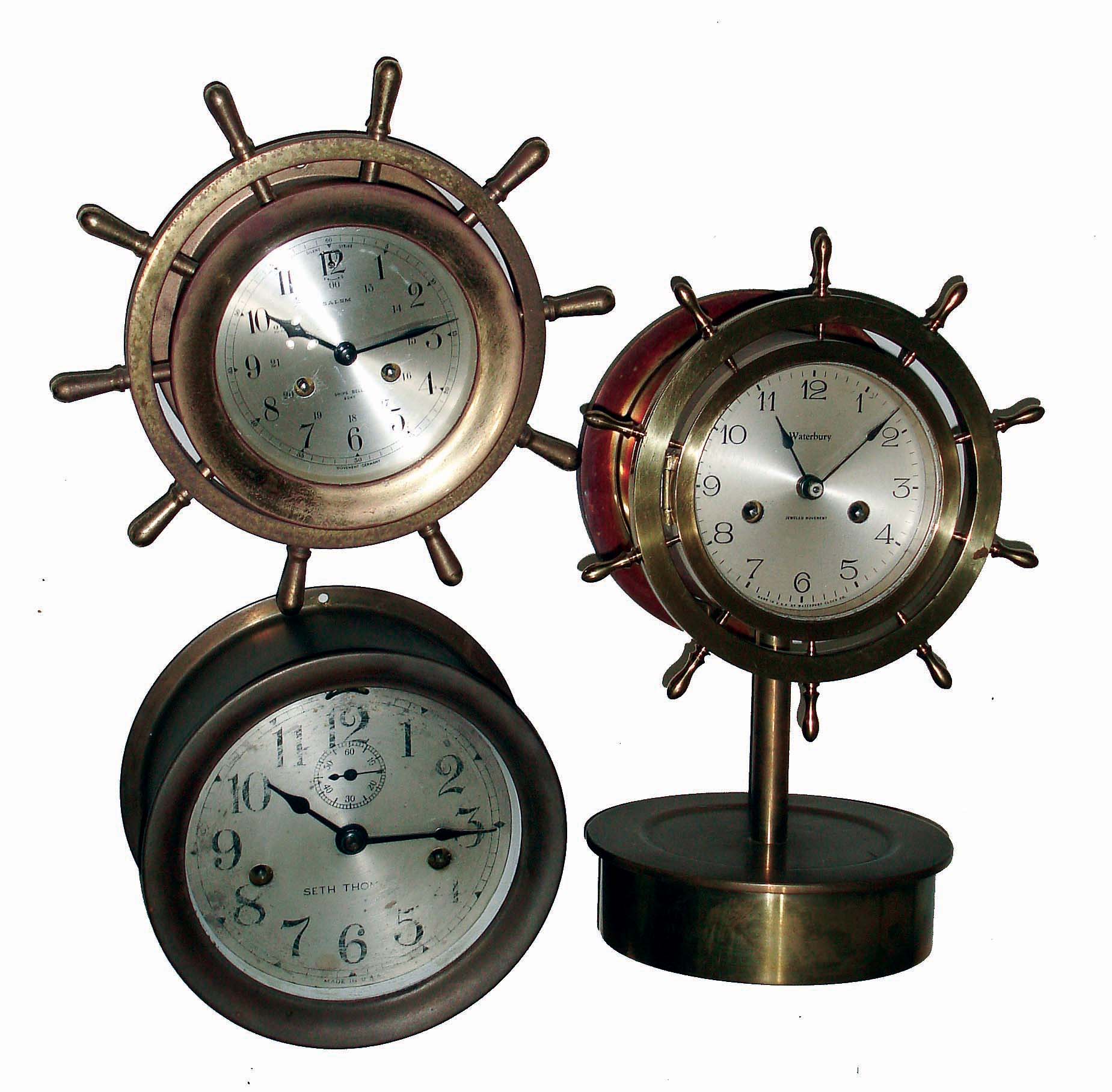 Clocks- 3 (Three) brass case, 8 days, hinged bezel marine clocks: Seth Thomas time only; Waterbury time and ship's bells yacht wheel on purpose-made stand; Salem, 8 days, time and ship's bells yacht wheel; 20th century — Antique Clocks Price Guide