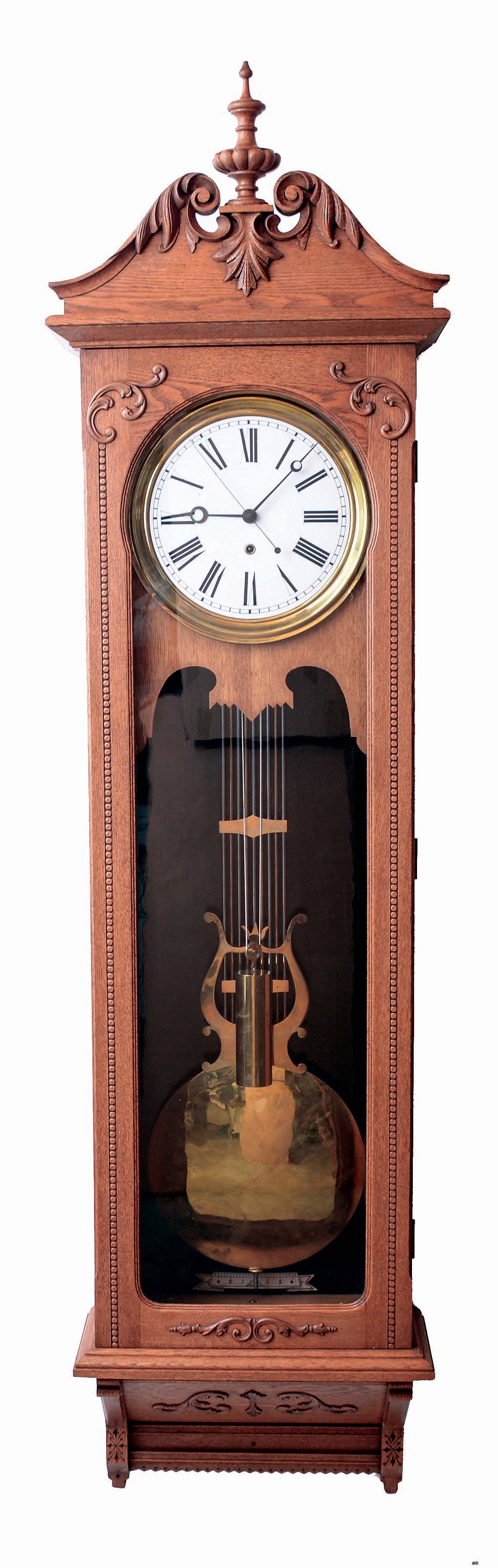 Wm. L. Gilbert Clock Co., Winsted, Conn., "Regulator No. 20", jeweler's regulator wall clock, 8 days, time only, weight driven American-made movement with gridiron pendulum, Graham deadbeat escapement and maintaining power in an oak case with a white enamel dial, c1910 — Antique Clocks Price Guide