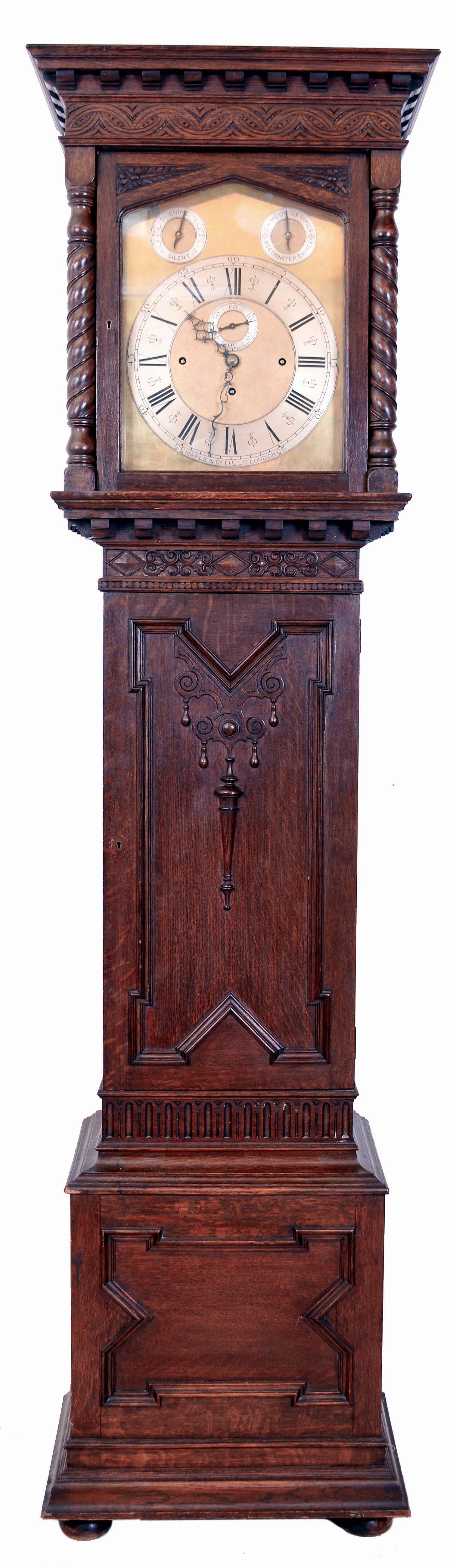 Maple &amp; Co., Ltd., London, England, tall clock, 8 days, time, strike and chime, playing Westminster or tune on 6 gongs, three brass weight driven unsigned Elliot movement in a carved oak case on bun feet with rope twist columns flanking hood. Brass dial with silvered chapter ring, second's bit, strike / silent and tune selectors, c1910 — Antique Clocks Price Guide