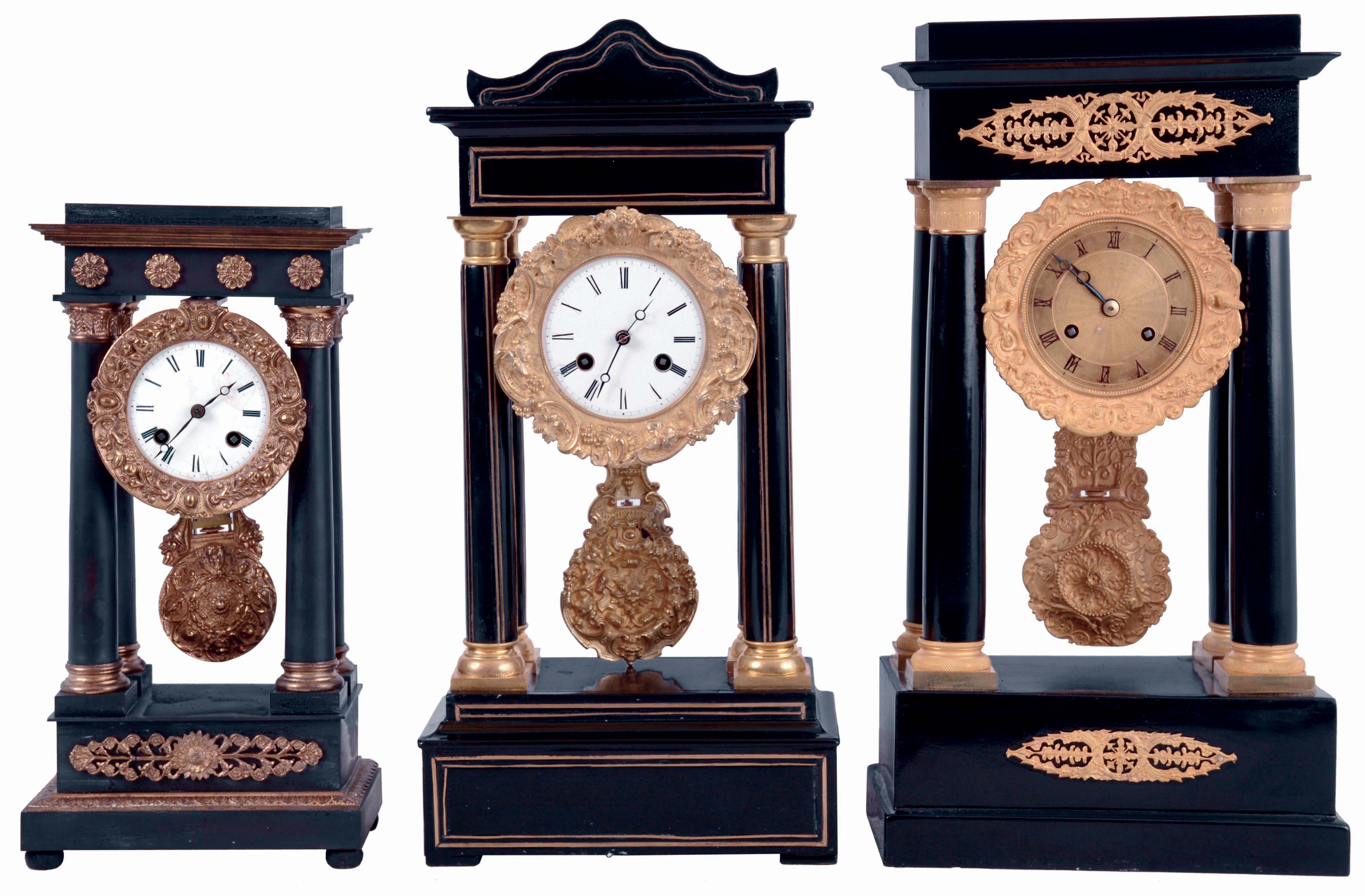 Clocks- 3 (Three): All French portico clocks, the first with ebonized wooden case and gilt mounts, Roman numeral engine turned dial, blued steel Breguet style hands, fancy gilt pendulum, 8 days, time and strike pendule a Paris movement, c1840, the next also with ebonized wooden case, with brass inlay, Roman numeral white enamel dial, blued steel Breguet style hands, fancy gilt pendulum, 8 days, time and strike pendule a Paris movement, c1860 and the last with gilt bronze case and gilt mounts, Roman numeral white enamel dial, blued steel Breguet style hands, fancy gilt pendulum, 8 days, time and strike pendule a Paris movement, c1850 — Antique Clocks Price Guide