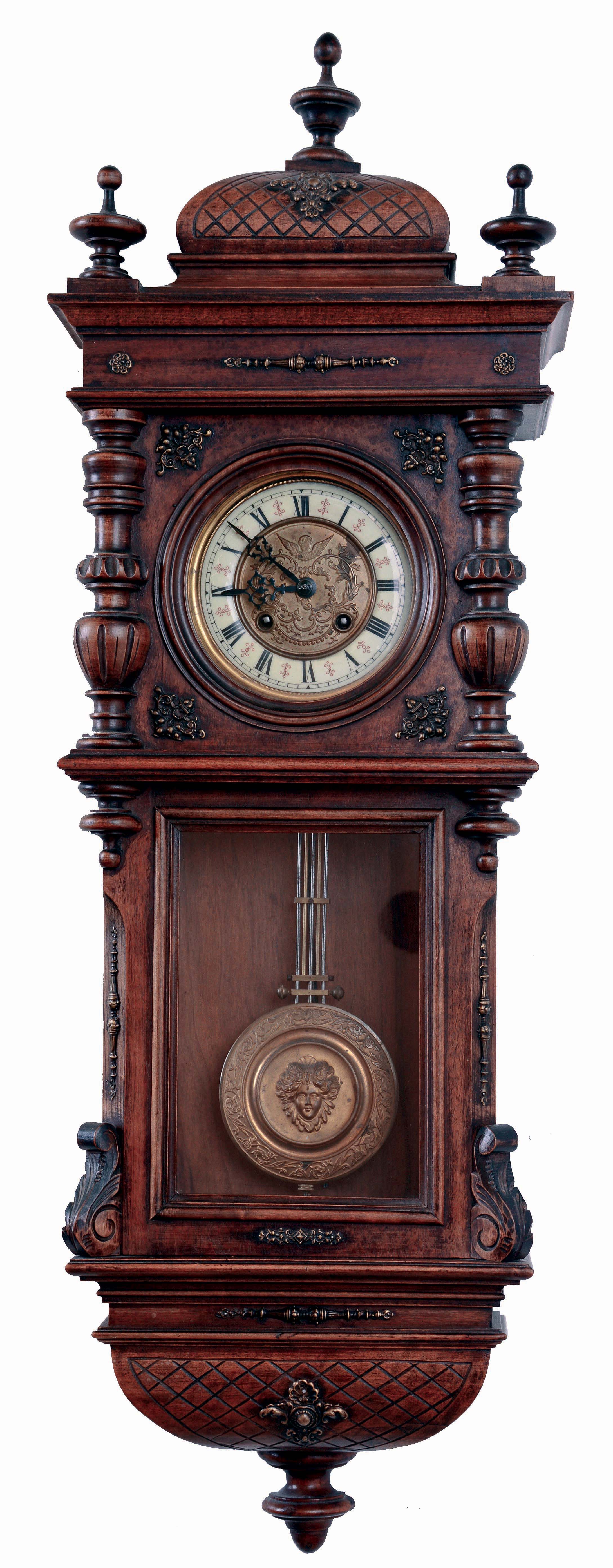 Germany, smaller walnut cased spring "Vienna" regulator, double door style, with embossed dial center bearing a cherubs face below 12, and the embossed pendulum with a similar large central cherubs face. 8 days, time and gong strike, c1900 — Antique Clocks Price Guide