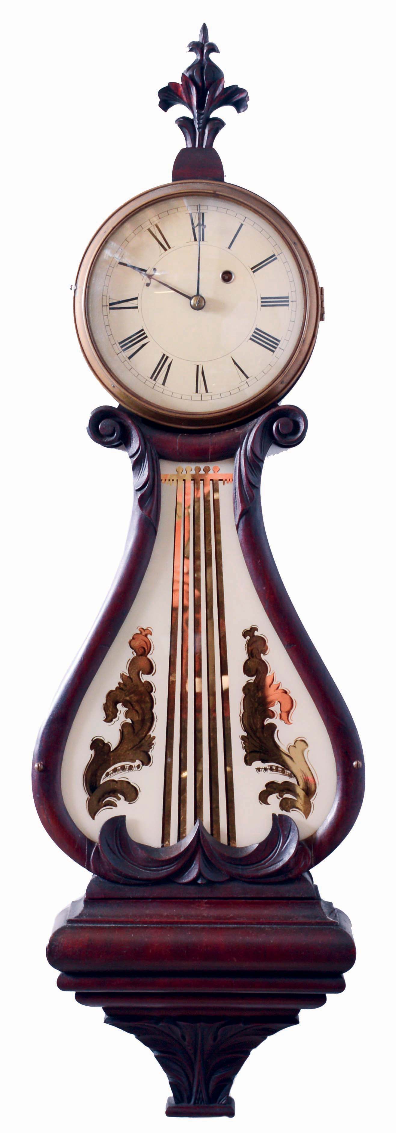 Boston area lyre clock, mahogany and mahogany veneer case with heavily molded base and acanthus carved bracket, throat panel with leaf and scroll carving and decorated tablet, brass bezel with convex glass, Roman numeral white painted metal dial, blued steel barbed hands, 8 days, weight driven timepiece movement, c1830 with alterations. — Antique Clocks Price Guide