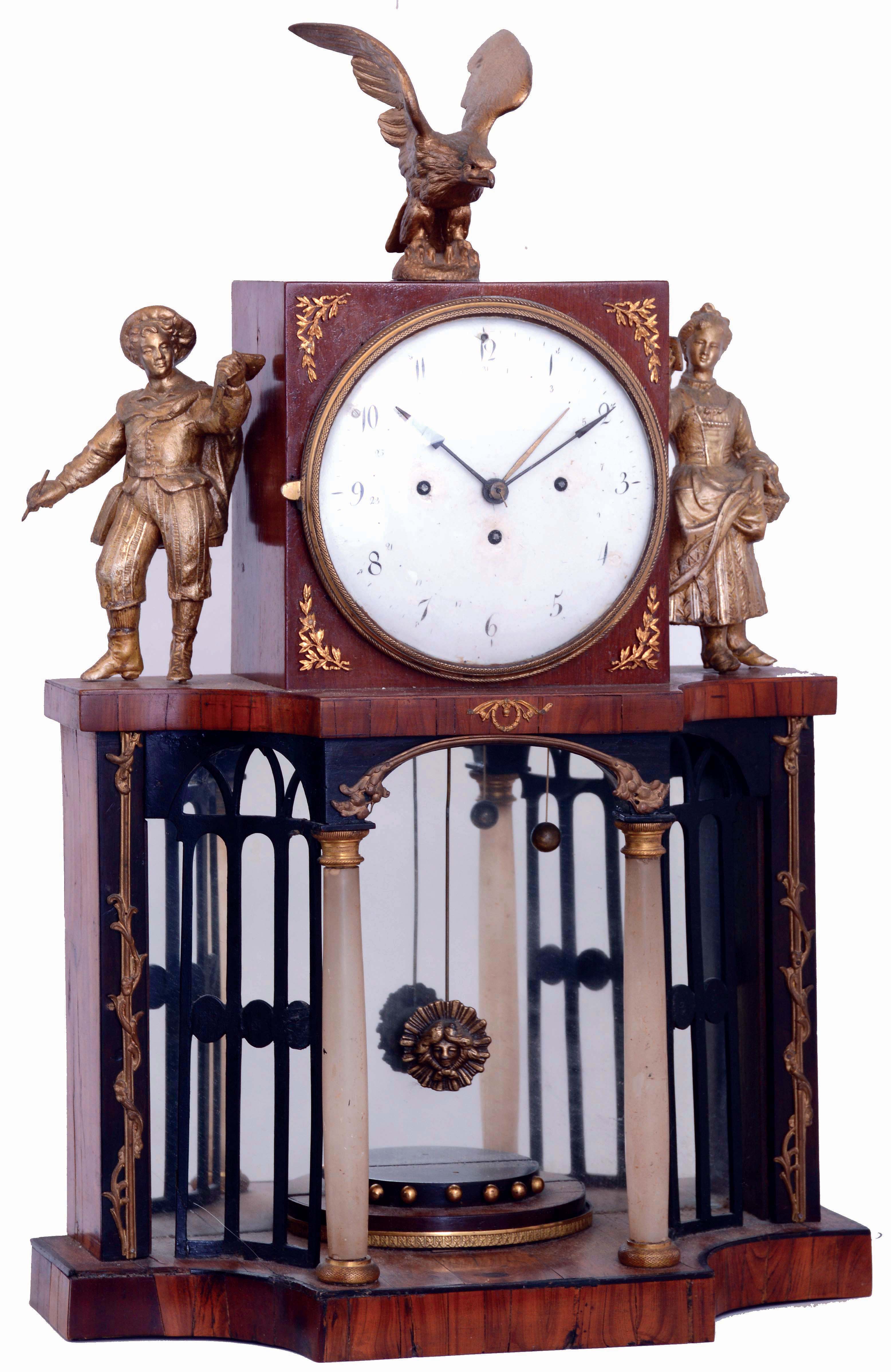 Austria, shelf or mantel clock, fruitwood case, base with arcaded portico with mirrored back, and alabaster columns supporting the square clock case, flanked by male and female figures and with eagle finial, Arabic numeral white enamel dial, 2 day grand sonnerie striking brass movement with date display, c1820 — Antique Clocks Price Guide