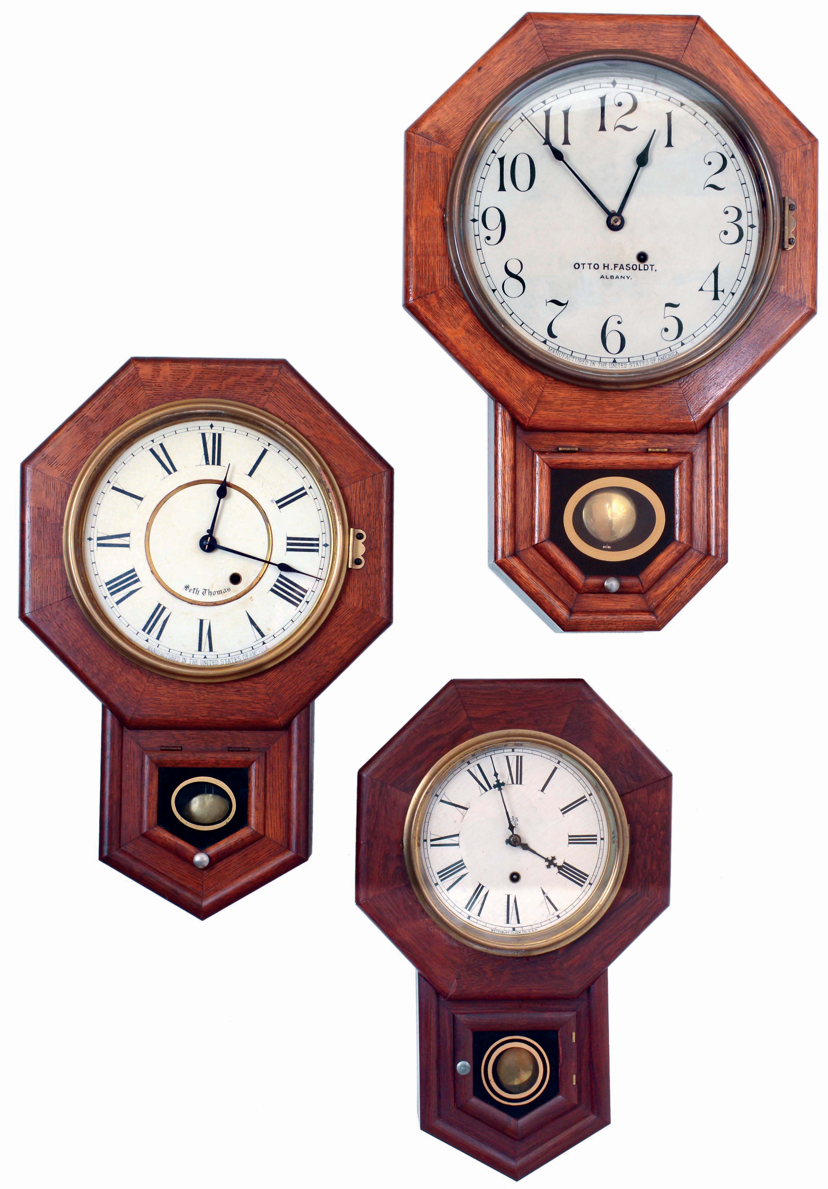 Clocks- 3 (Three): (1) Seth Thomas Clock Co., Thomaston, Conn., 8 days, spring driven brass movement drop octagon wall timepiece. Dial is labeled "Otto H. Fasoldt/ Albany", a jeweler, watchmaker and son of Charles Fasoldt of Albany, NY, well known maker of precision watches, regulators and tower clocks. (2) Seth Thomas Clock Co., Thomaston, Conn., 8 days, spring driven brass movement drop octagon wall timepiece. (3) Waterbury Clock co., Waterbury, Conn., "6 Inch Drop", 8 days, spring driven brass movement drop octagon wall timepiece, all early 20th century. — Antique Clocks Price Guide