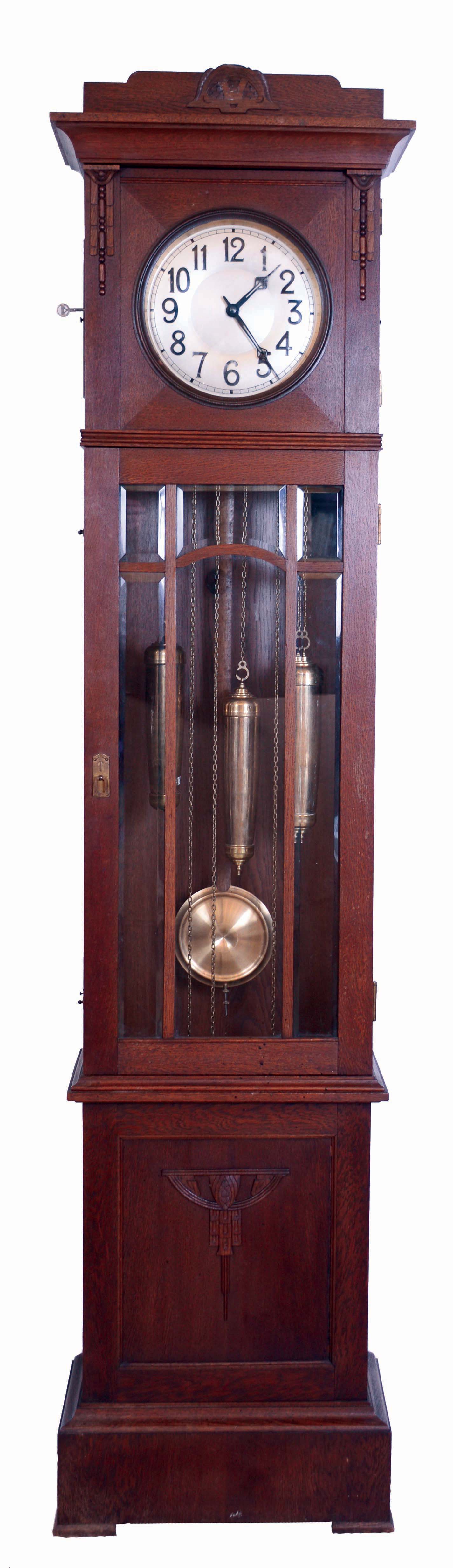 Lenzkirch, Germany, tall clock, "AGUL" 8 days, time, strike and chime on gongs, brass weight driven movement in an oak case with six paneled beveled glass trunk and Art Deco plinth with brass dial, serial #1357779 c1920 — Antique Clocks Price Guide