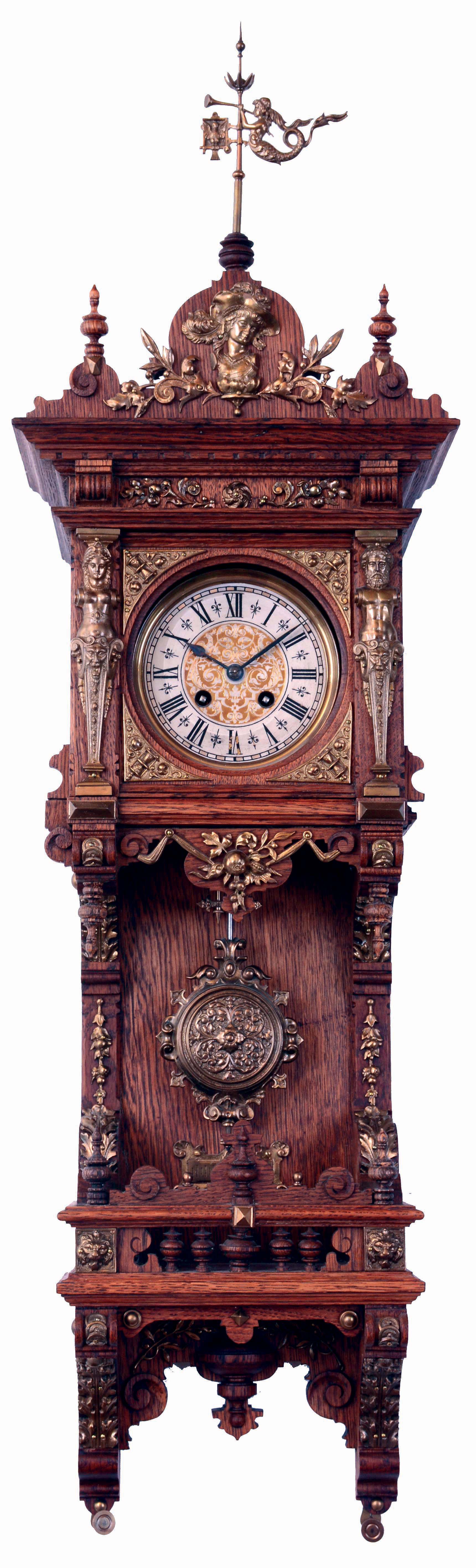 Lenzkirch, Germany, miniature Freischwinger model No. 671, oak and oak veneer open well case with turned and scroll sawn elements, and mounted with a profusion of cast brass ornament, the removable top crowned with a brass mermaid form wind vane, Roman numeral silvered dial with decorative center, blued steel hands, cast brass pendulum with scrolls and foliate ornament, spring driven, 8 days time and strike movement, serial #923583, c1895 — Antique Clocks Price Guide