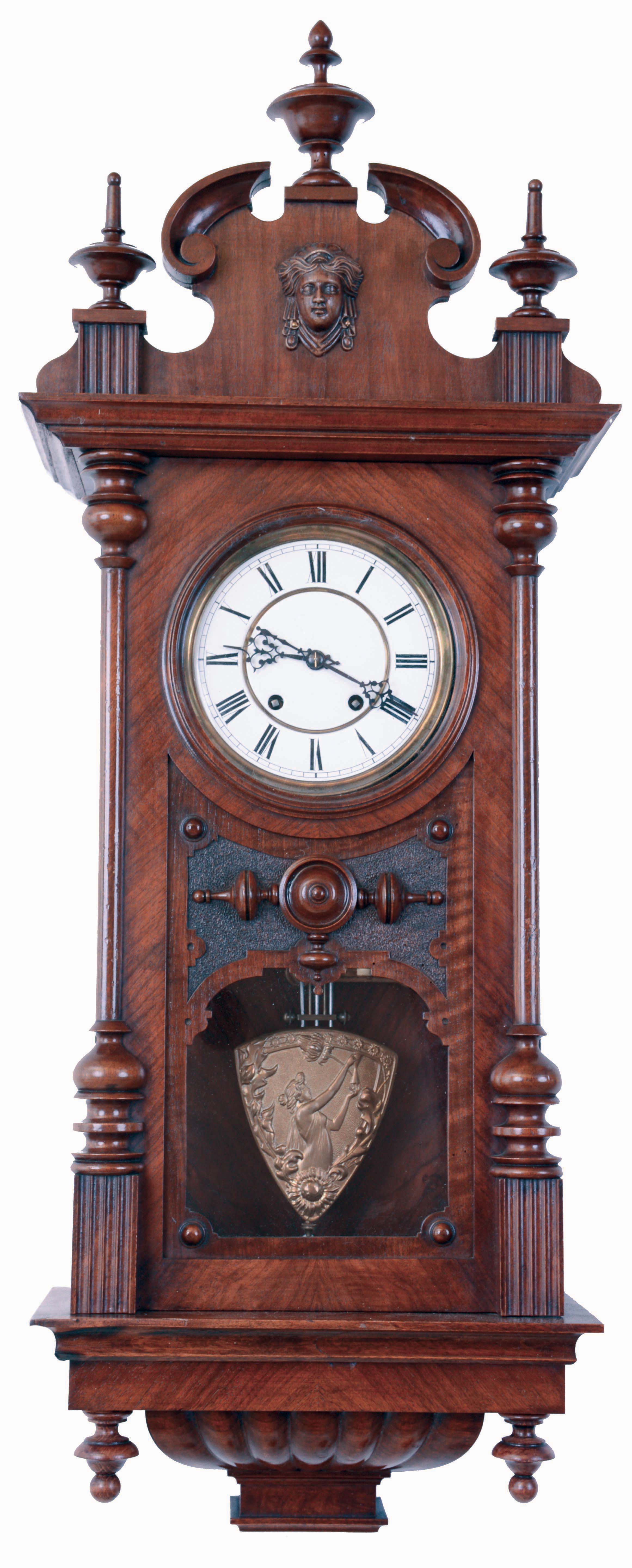 Lenzkirch, Germany, hanging regulator, walnut and walnut veneer case, door with turned columns resting on fluted plinths, and with applied, turned ornament, base with lobed bracket and turned drops, top with turned finials, carved scrolls, fluted plinths, and central female mask, Roman numeral white enamel dial, blued steel hands, pendulum with triangular ball, and repousse ornament in the Jugendstil style, 8 days time and strike movement with ting tang quarters on two gongs, serial #999918, c1895 — Antique Clocks Price Guide