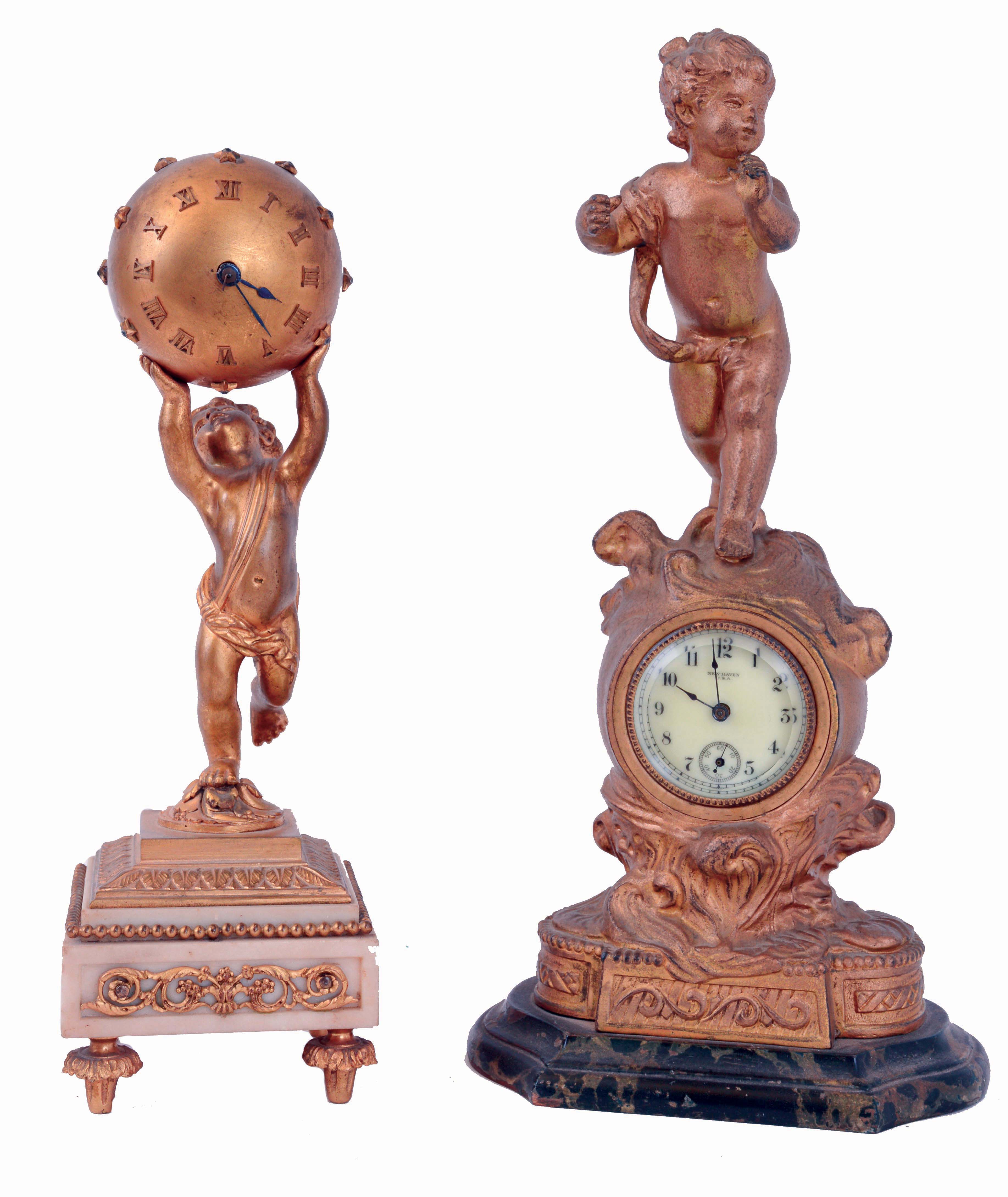 Clocks- 2 (Two): Both desk clocks, one a New Haven on a marbled base supporting a gilt spelter case and surmounted by a putto, enamel dial and 30 hour timepiece, the other French, a gilt putto holding the spherical case above his head, and standing on a marble base with gilt ornament, 8 days, timepiece with lever platform, both c1900 — Antique Clocks Price Guide