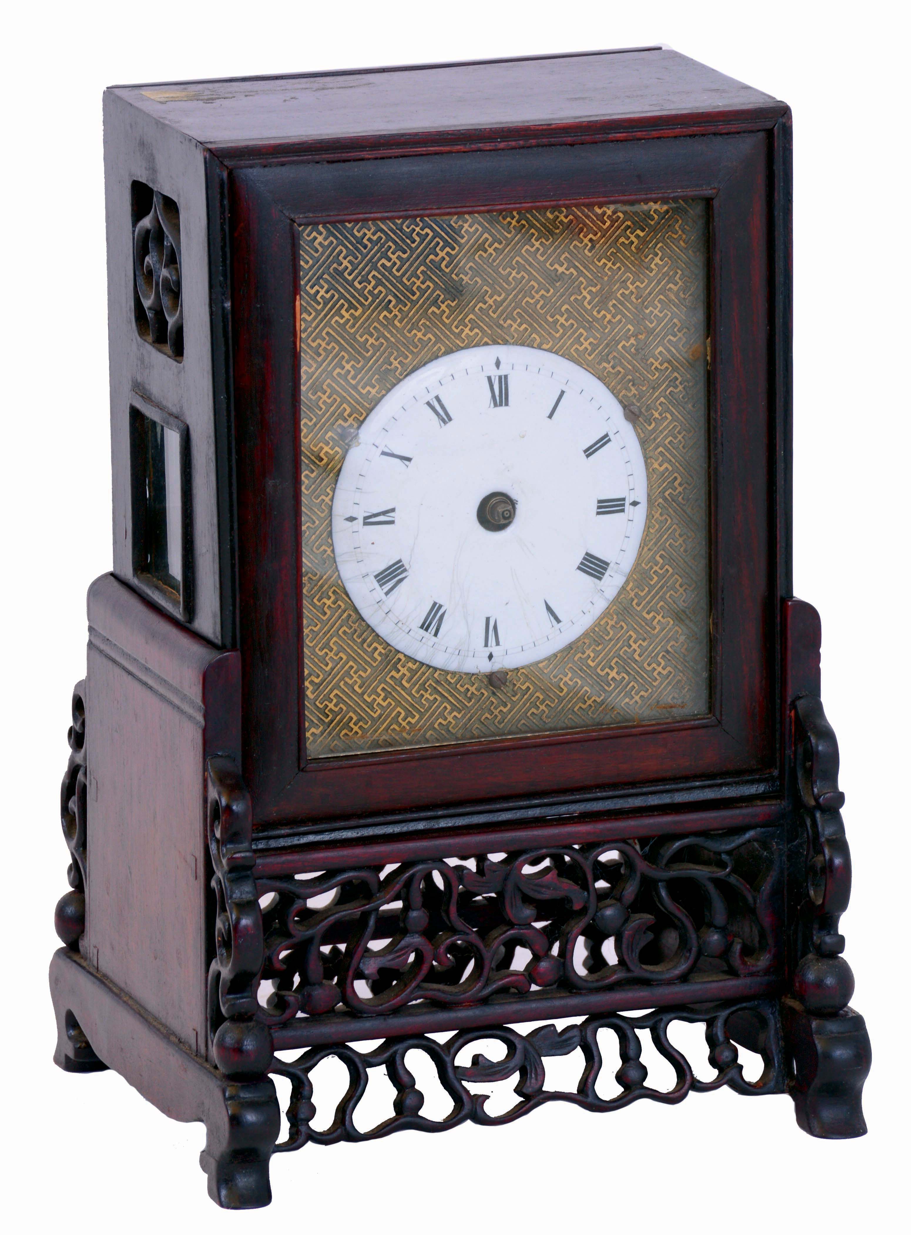 China, bracket clock, camphor wood case with glazed panels, resting on a pierced and carved base, Roman numeral white enamel dial mounted to a brass plate, brass time and strike fusee movement with verge escapement, and engraved back plate — Antique Clocks Price Guide