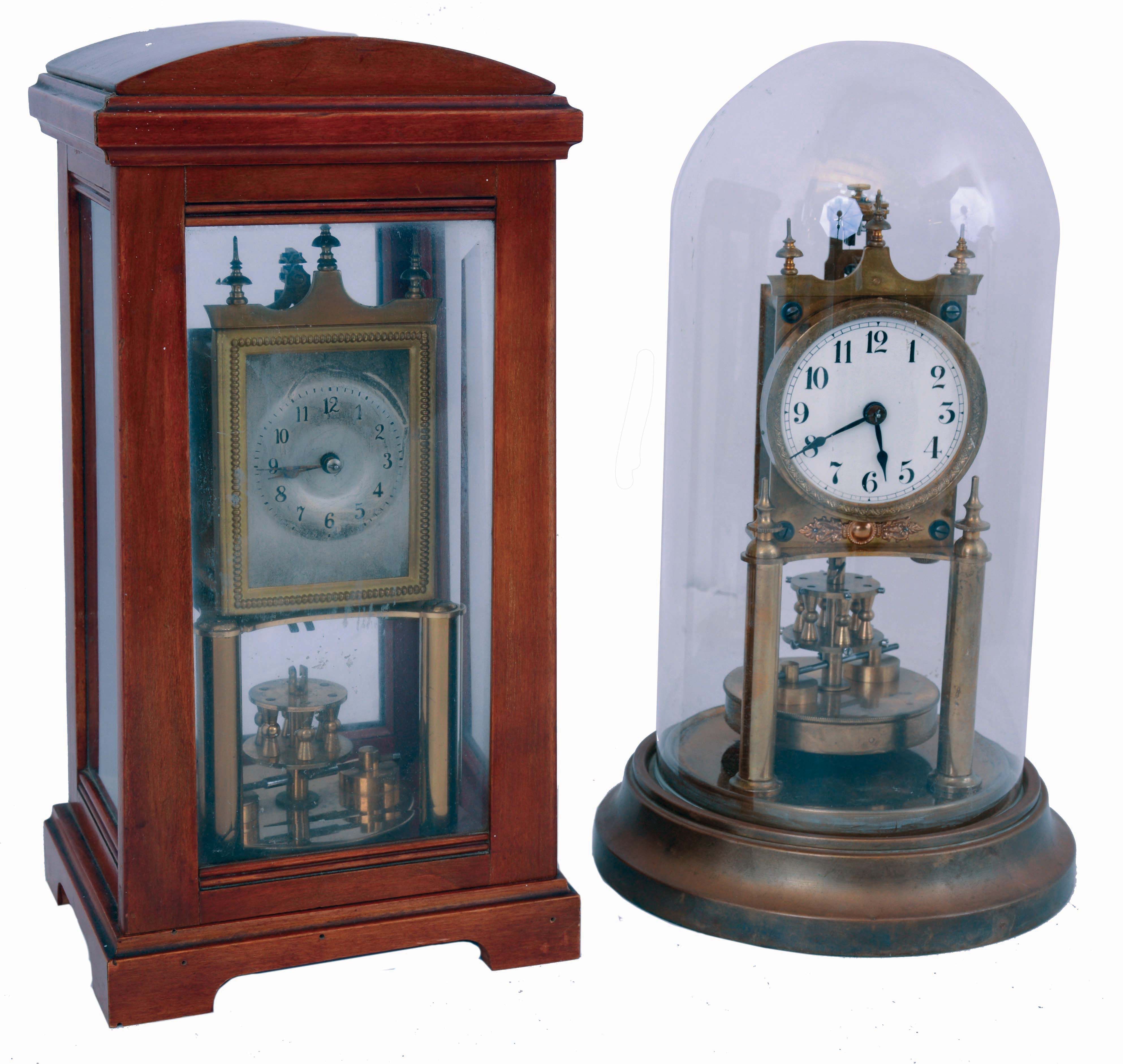 Clocks- 2 (Two): Early anniversary clocks, one in a wooden case, back plate marked "BHA", the other on a brass base with dome, marked "Gustav Becker", both with disc pendulums, c1920 — Antique Clocks Price Guide