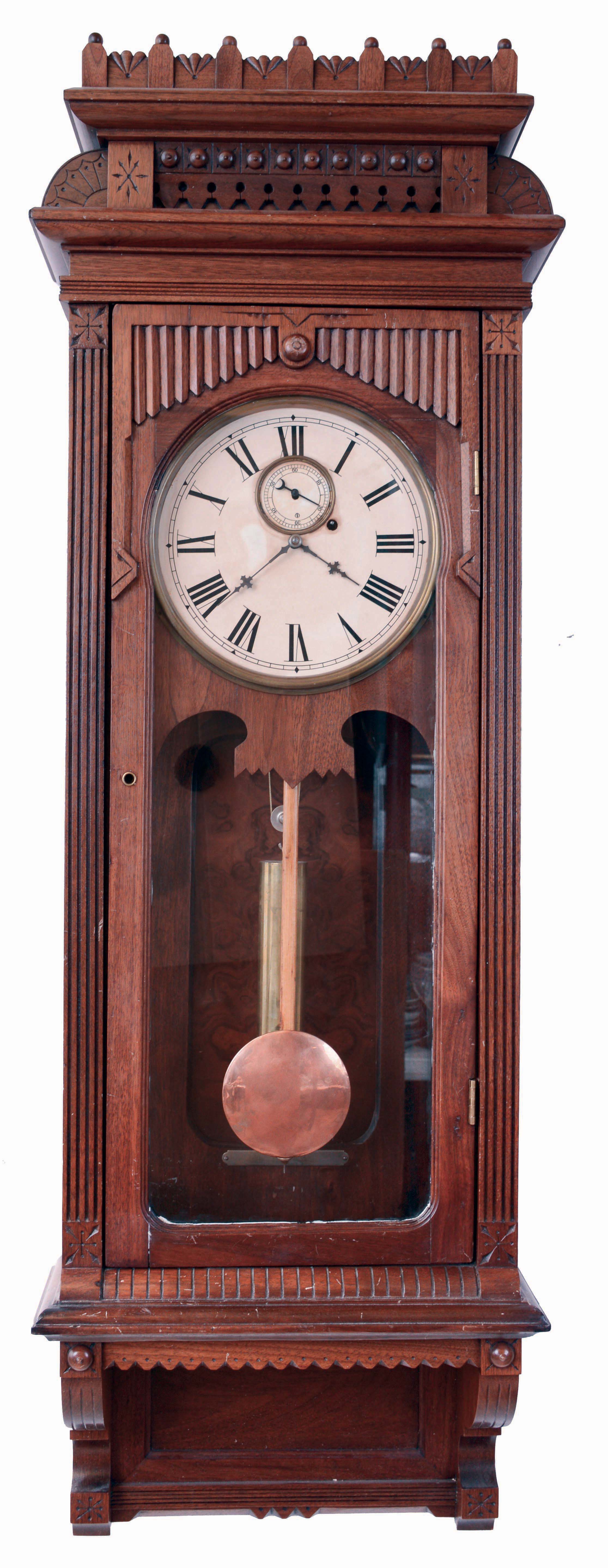 Wm. L. Gilbert Clock Co., Winsted, Conn., "Regulator No. 10 Hanging", 8 days, weight driven brass movement wall regulator, c1901 This is a variation from the model shown in the catalog as the case is walnut and the crest is a little different. — Antique Clocks Price Guide