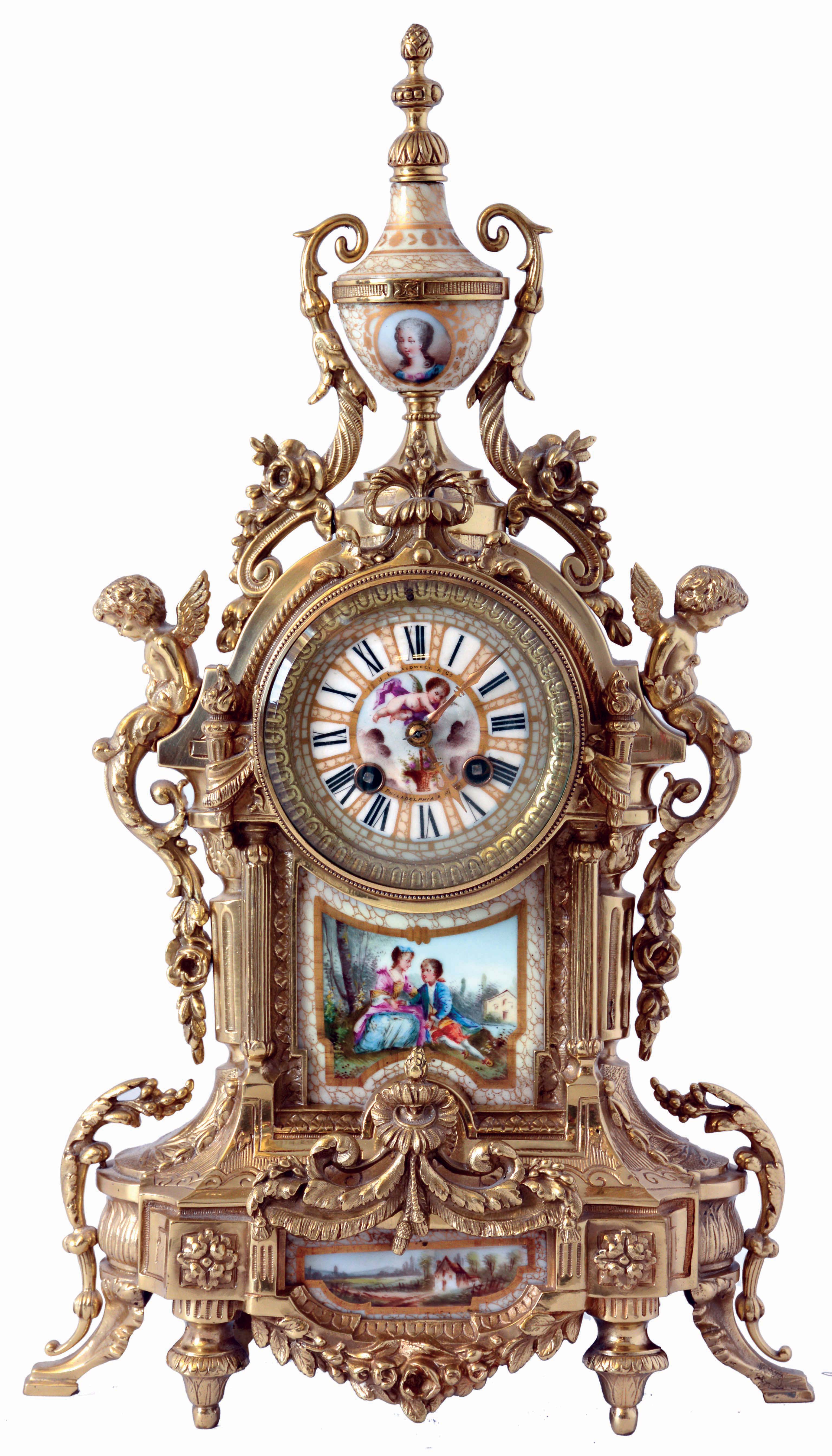 Samuel, Marti, France, for J.E. Caldwell &amp; Co., Philadelphia &amp; Paris, mantel clock, cast brass case with architectural and naturalistic ornament, the front set with a painted porcelain panel depicting a young couple in a landscape, the top with porcelain urn decorated with a portrait of a young woman, Roman numeral porcelain dial with gilding, and putto with basket of flowers, 8 days, time and strike pendule a Paris movement, c1900 — Antique Clocks Price Guide