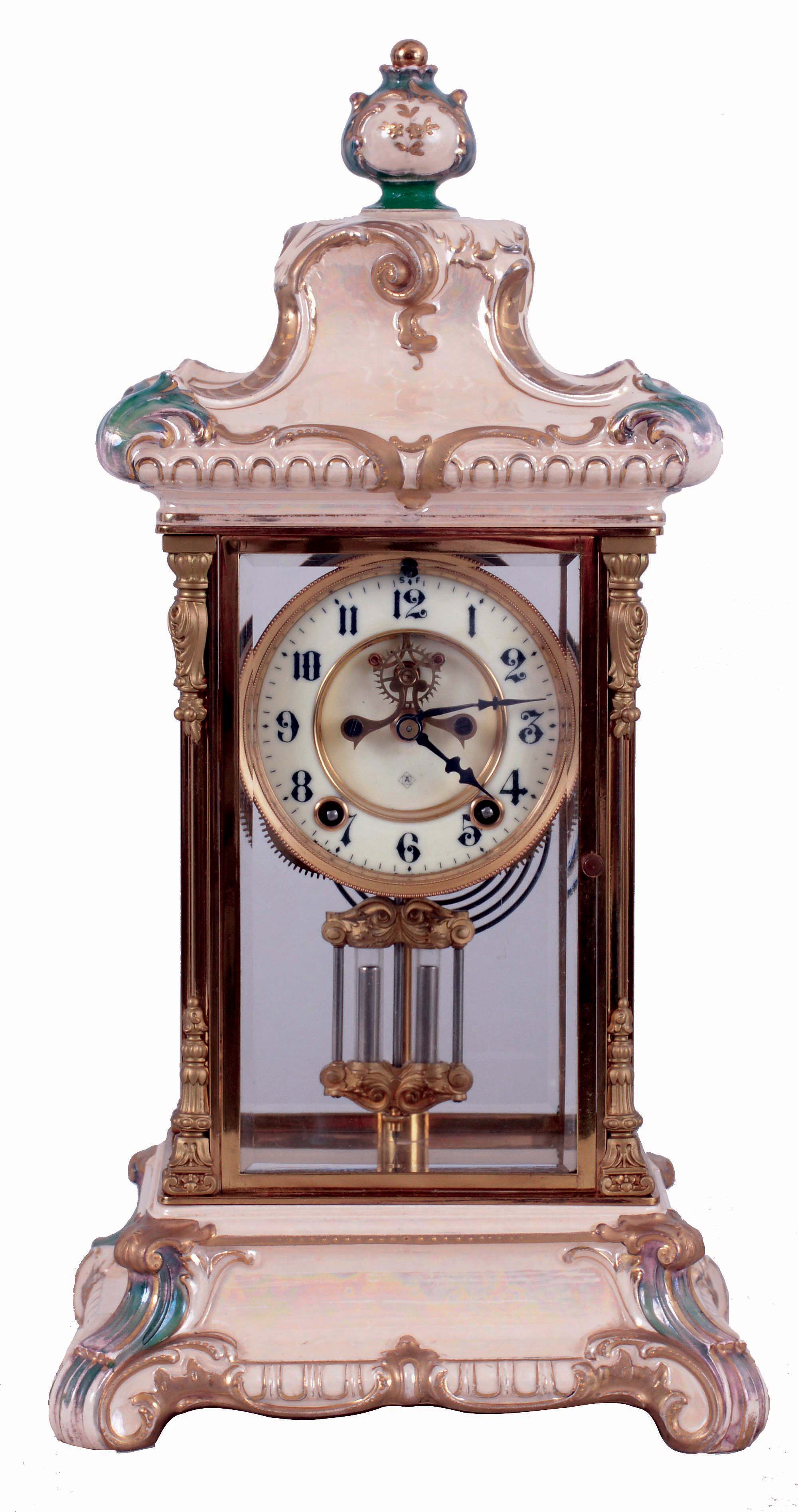 Ansonia Clock Co., New York, NY, "Crystal Regulator No. 3" in a gilt and brass case with a Royal Bonn top and base and a spring driven, 8 days, time and hour/half-hour strike movement with a visible escapement, c1906. — Antique Clocks Price Guide