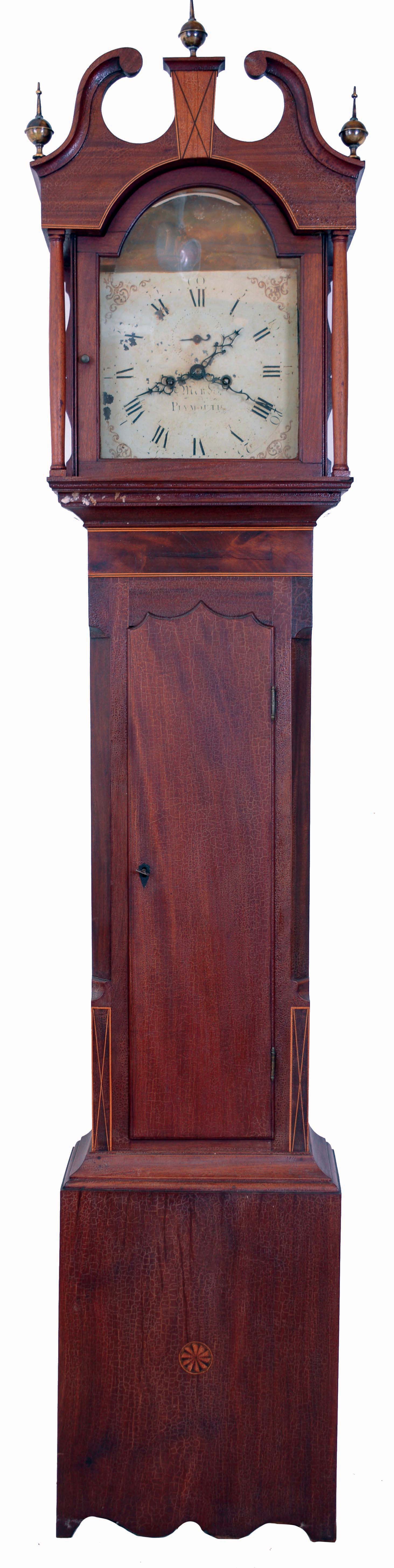 Benjamin Mends, Plymouth, England, tall case clock, 8 days, time and strike, weight driven movement in a mahogany and mahogany veneer case with broken arch top and inlaid plinth and banded inlay above and flanking trunk with three brass finials and painted metal dial with sweep calendar, c1810. — Antique Clocks Price Guide