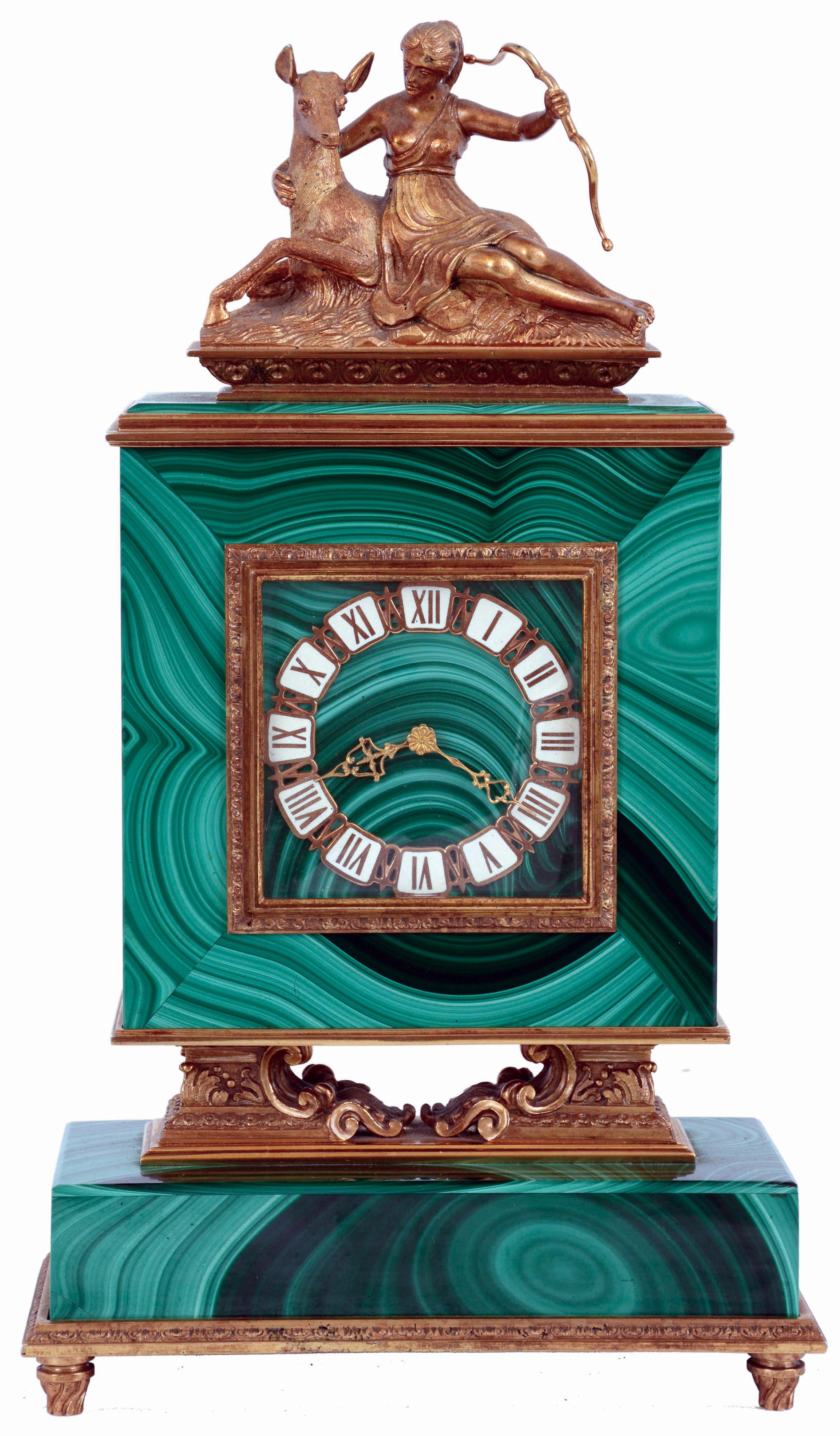 Switzerland, malachite and silver gilt desk or bedside clock, stone base with gilt molding and feet, the square clock case on cast architectural supports with scrolls and acanthus leaf decoration, the top with gilt figure of Diana and a deer, rear door gilt and with engraved decoration, Roman numeral gilt and white enamel chapter ring with fancy gilt hands, time and alarm movement with lever escapement, c1960 — Antique Clocks Price Guide