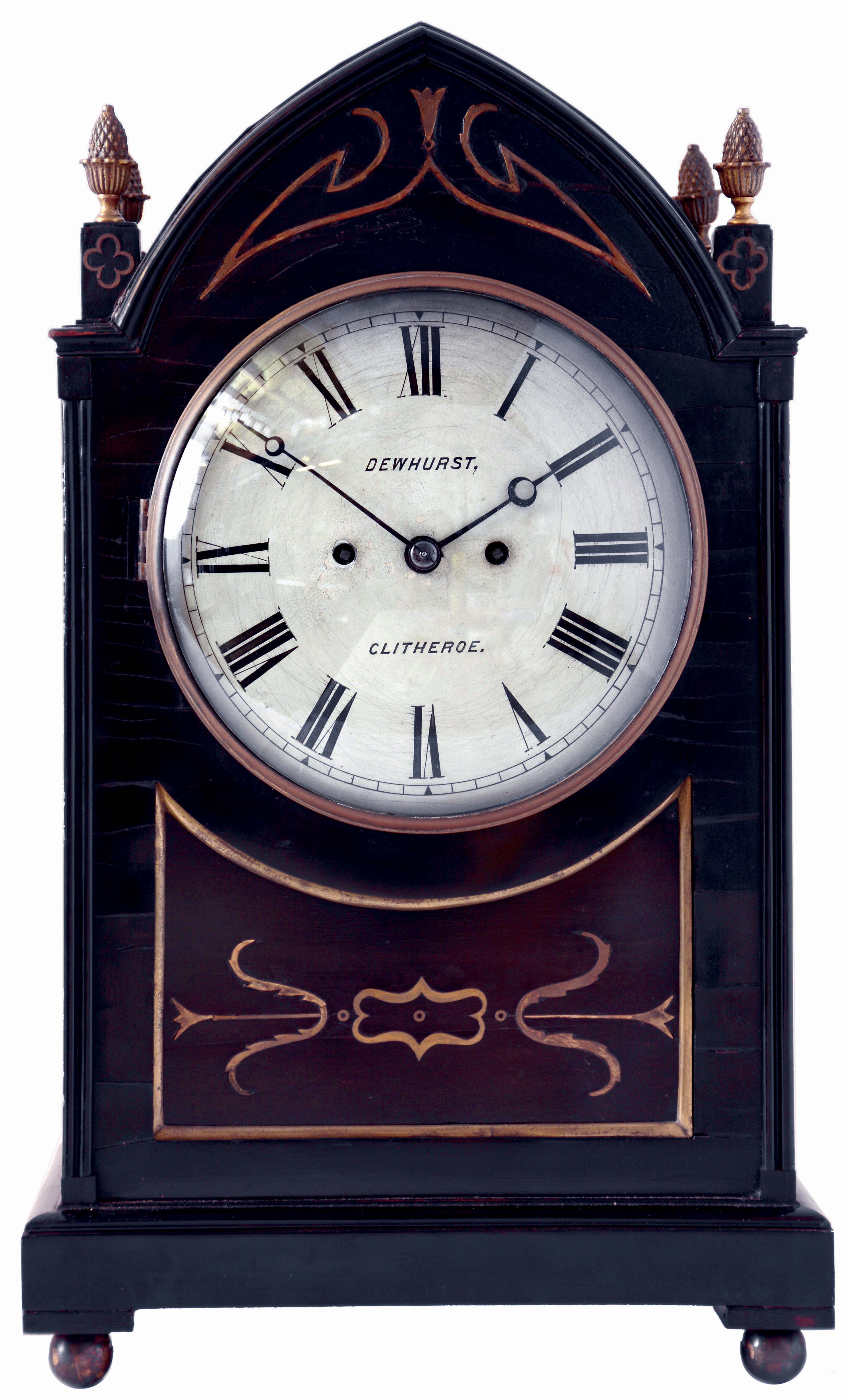 Dewhurst, Clitheroe, England, bracket clock, the lancet arch form oak case with ebony moldings, veneers, and brass inlay, pierced brass gothic frets at the case sides and with pineapple finials, brass bezel with convex glass, Roman numeral white painted convex sheet iron dial, blued steel Breguet style hands, 8 days, time and strike fusee movement sounding the hours on a large bell, c1825 — Antique Clocks Price Guide