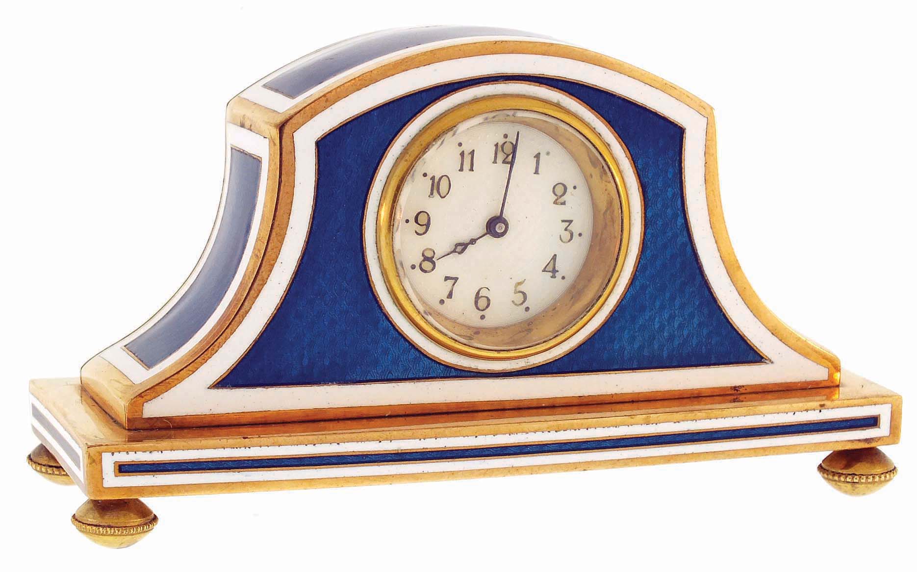 Desk clock, gold plated Napoleon hat form case, blue guilloche enamel panels with white enamel borders, Arabic numeral white guilloche enamel dial, 30 hours key wind and set movement with cylinder escapement, c1900 — Antique Clocks Price Guide