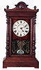 Seth Thomas Clock Co., Thomaston, Conn., "Atlas" mantel clock in a walnut case with three train, 8 days, spring driven movement, striking the quarter hours on 2 cup bells and hours on a cathedral bell, c1887.