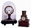 Clocks- 2 (Two): (1) Seth Thomas' Sons & Co., New York, candle stand clock, enamel dial, 8 day timepiece with glass dome, (2) English night projection table clock, 30 hour timepiece on wooden base, marked "J.C. Vickery Regent St W."