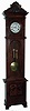 Lenzkirch, Germany, tall case clock, 8 days, time and bell strike, two brass--weight driven movement in a walnut case with an ornately carved top, applied carvings to base, cartouches on either side of door and white enamel dial, serial # 474673, c1879