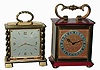Clocks- 2 (Two) Gubelin, Swiss, 8 days, brass and glass desk timepieces: one alarm with red enamel panels; one double-side partner's clock with twisted columns; mid 20th century