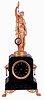 Guilmet, France, mystery clock, black slate case with incised line decoration, lion mask handles, and paw feet, surmounted by a gilt female figure, her right hand held aloft with a torch, and suspending the pendulum. Pendulum impulsed through the nearly imperceptible movement of the gilt base on which the she stands, gilt Roman numeral black slate dial, gilt spade hands, 8 days time and strike movement with crank and stirrup escapement, back plate signed "Brevete GLT S.G.D.G." and numbered 943, c1875
