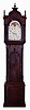 English tall clock, 8 days, time and strike, on gong, weight driven movement in a mahogany and crotch mahogany veneer case with reeded columns flanking hood and base plinth, and rope turned columns flanking trunk, flame finials on hood with carved rosettes on goose neck crest and Gothic arched crotch mahogany trunk door. The painted iron dial has moon phase, date calendar and painted morning glory spandrels, c1840