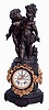 Ansonia Clock Co., New York, NY, "Florida" base with figure "No. 1089", shelf clock, 8 days, time and strike, spring driven movement in a spelter case with gilded floral swags, surmounted by detachable figural spelter putti with a white enamel dial and open escapement, c1900