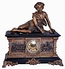 Ansonia Clock Co., New York, NY, "Columbia" figural shelf clock, 8 days, time and strike, spring driven movement in a enameled cast iron case with applied cast friezes depicting Medieval military scenes, resting on large cast brass front feet surmounted by a spelter statue of shepherd boy reclining, and a extra fancy cast brass dial with applied Roman numerals and open escapement, c1890