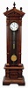 Lenzkirch, Germany, standing regulator, walnut and matched walnut veneer case of architectural form, ornamented with applied moldings, turned elements, and carving, Roman numeral silvered dial with brass bezel, blued steel Breguet style hands, and with center seconds hand, jeweled brass 8 day timepiece movement with deadbeat escapement and jeweled Vulliamy pallets, brass clad weight, 5 rod gridiron pendulum with lead filled brass ball, adjusting nut with engraved scale and pointer, serial #949560, c1890