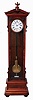 Lenzkirch, Germany, standing regulator, model 478, walnut and matched walnut veneer case of architectural form, ornamented with applied moldings, turned elements, and carving, and with a drawer in the base, and resting on turned feet, Roman numeral white enamel dial with brass bezel, blued steel Breguet style hands, and with center seconds hand, month going jeweled brass timepiece movement with deadbeat escapement and jeweled Vulliamy pallets, brass clad weight, ebonized pendulum rod with brass ball, rating nut with engraved scale and pointer, serial #404071, case bottom marked "G. Bauer Anno 1873"